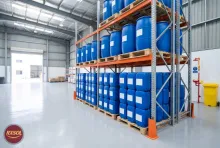 Sealed blue jerry cans and drums of chemical descaling liquid in a clean warehouse in Barka, Oman