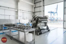 Marine engine overhaul workshop at an Omani port with cleaned pistons and a 25 litre jerry can of carbon remover